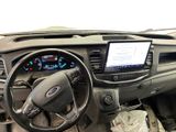 a dashboard of a vehicle with a large screen on the dash