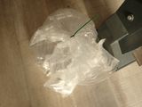 a plastic bag on the floor next to a metal object