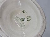 a close up of a white bowl with writing on it