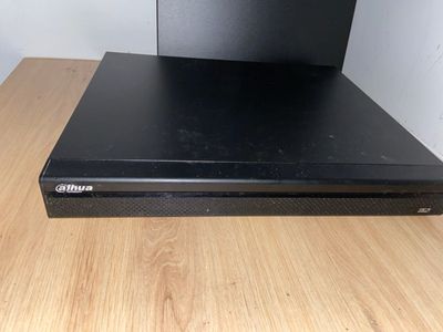 a close up of a dvd player sitting on top of a wooden table