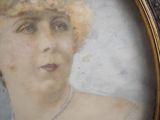 an old picture of a woman in a hat with a pearl necklace