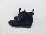 navy blue lace up boots with black soles on a white surface