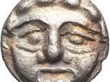 a close up of a coin with a face on it