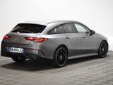 the rear end of a silver mercedes cla parked on a checkered floor