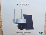 the box of the camera is open on the wooden floor