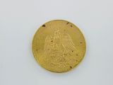 an image of a gold coin sitting on top of a white surface