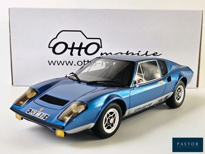 the blue model of a sports car is sitting on a white surface