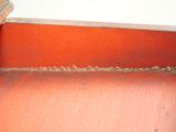 a close up of a piece of red fabric on a chair
