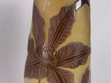 a vase with a floral design on it sitting on a table
