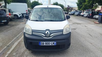 a small white van parked on the side of the road