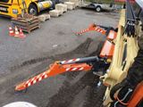 a man that is standing next to a construction vehicle