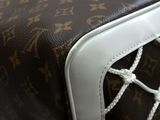 a close up of a brown and white bag on a table