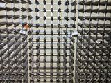 bottles of wine are arranged in a wine rack in a wine cellar