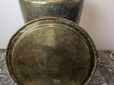 an old brass plate sitting on top of a marble table