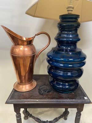 une table sur laquelle se trouvent une lampe et un vase