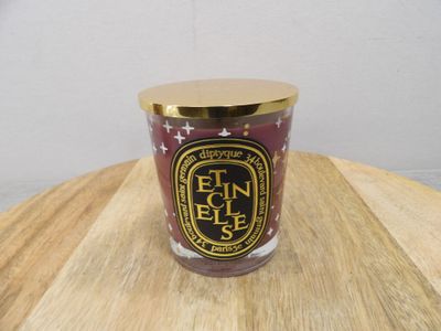 the candle is sitting on top of a wooden table