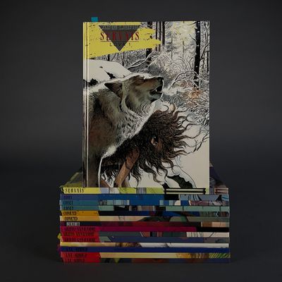 books stacked on top of each other on a black surface