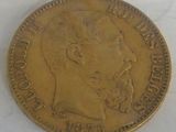 an old gold coin with a man ' s face on it