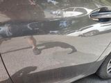 a reflection of a person on the side of a car