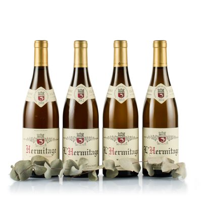 three bottles of wine sitting next to each other on a white surface