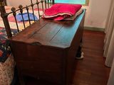 a bed with a wooden headboard and foot board in a room