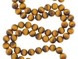 un collier composé de perles « œil-de-tigre » orné d'une breloque papillon en or