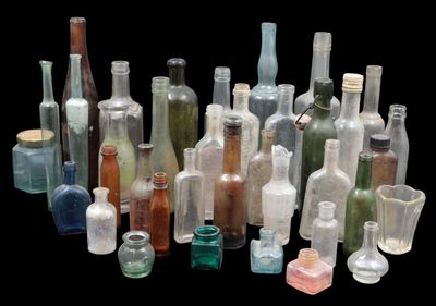 a lot of bottles that are sitting together on a table