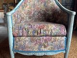 an image of a chair with a floral upholstered seat in a living room
