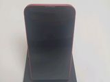 a black and red cell phone sitting on top of a stand