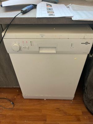 a white dishwasher sitting on top of a kitchen counter