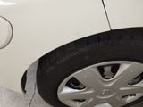 a close up of a tire on a white car
