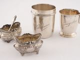 three pieces of silverware are sitting on a white surface