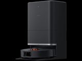 a close up of a black speaker with an orange light on it