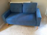 a blue couch that is sitting in the corner of a room