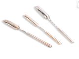 three silver spoons and a fork sitting next to each other