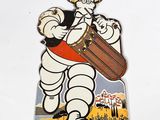 an image of a pin with an image of a man in a hat playing a drum