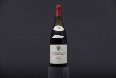 a bottle of wine sitting on top of a glass table