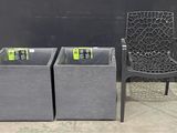 a chair and two bins that are sitting next to each other