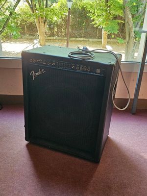 a guitar amp sitting on the floor in front of a window