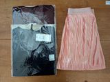 two pairs of skirts sitting on a table next to each other