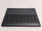 the laptop is sitting on a white surface with a black cover