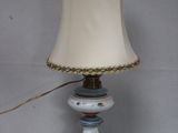 a lamp that is sitting on a table next to a wall