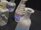 several bottles and a bowl on the table