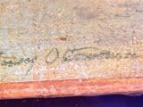 a close up of a piece of wood with writing on it