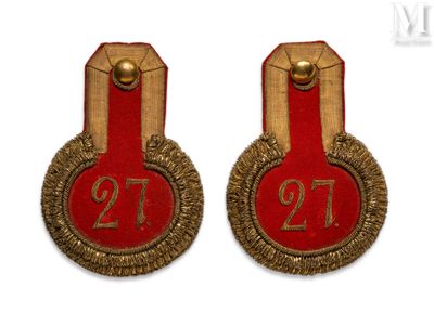 pair of red and gold badges with the number twenty on them