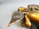a gold statue of a person with a chain around it