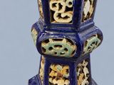 a blue vase sitting on a table with a blue background