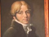 portrait of a man in a black coat with a white collar