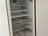a white refrigerator with its door open in a kitchen