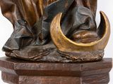a statue of a man holding a knife on a pedestal
